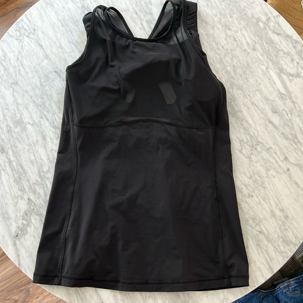 Black Lululemon top with mesh details and built in bra. Size 10.